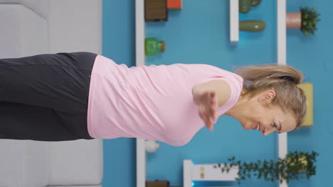 Vertical-video-of-Woman-doing-arm-exercises-at-home.